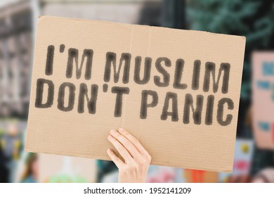 The phrase " I’m Muslim don’t panic " on a banner in men's hand with blurred background. Hate. Equality. Human rights. Protest. Anti Muslim. Anti-muslim. Multiracial. Racism