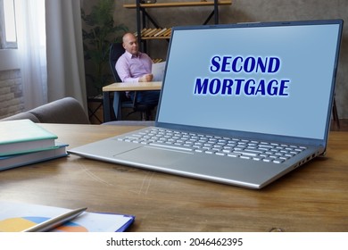 Phrase SECOND MORTGAGE On The Data Processor. Businessman Working At Work Table 
