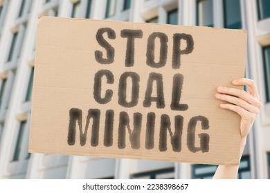 The phrase " Stop coal mining " is on a banner in men's hands with blurred background. Stone. Conservation. Ecosystem. Government. Negative. Political. Pollution. Resource. Rule. Illegal. Politic - Shutterstock ID 2238398667