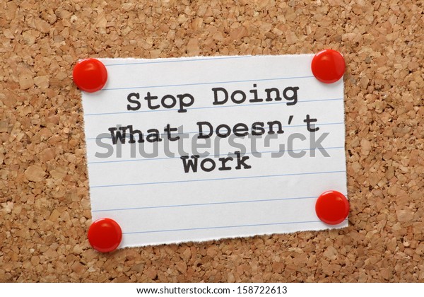 The phrase Stop Doing What Doesn\'t Work on a\
paper note pinned to a cork notice board. In both business and our\
own lives we have to look for efficiency and best practice to move\
forward.