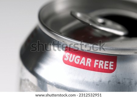 The phrase Sugar Free printed in red on a soft drink can