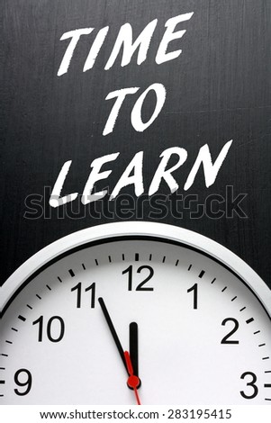 The phrase Time To Learn in white text on a blackboard above a modern wall clock