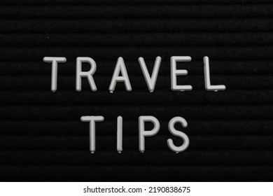 Phrase Travel Tips On Black Letter Board As Background, Top View