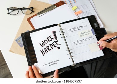 Phrase Work harder written in a notebook