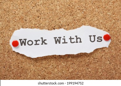 The phrase Work With Us typed on a piece of paper and pinned to a cork notice board