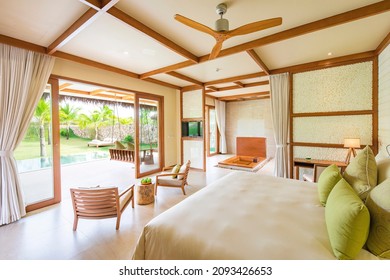 Phu Quoc City, Vietnam - October 2020: Beautiful Bright Bedroom In A Luxury Hotel With A Large Bed And Modern Furniture, Large Glass Doors Overlooking The Greenery. Luxury Resort Apartment.