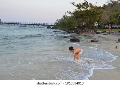 Phu Quoc, Vietnam - February 18, 2020: Kid Playing On The Shore Of Rock Island In Phu Quoc