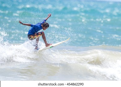 PHUKET - JULY 17: unidentified surfer in action catching waves in rainy season at Kata beach Phuket on July 17, 2016 in Kata beach, Phuket, Thailand.