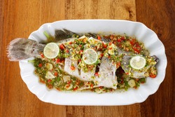 Phuket Seafood – Steamed Snapper With Lemon Sauce Isolated On Wooden Background. Close-up And Soft Focus Taken.