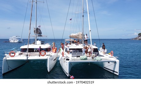 Phuket, Thailand, 14, November, 2020: A group of friends met in the water area on sailing catamarans to have fun together