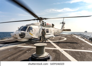 PHUKET, THAILAND - APRIL 9, 2019:  Sikorsky MH-60S Seahawk Helicopter Lands On The Flight Deck Of The HTMS. Bhumibol Adulyadej Stealth Frigate Of Royal Thai Navy With Air Operator Prepare For Take Off