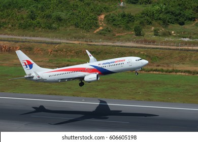 Phuket, Thailand. December 25, 2016. Malaysia Airlines Boeing 737-800 Reg. 9M-MSA Airborne Taking Off from Phuket International Airport with Shadow on Runway. Set as Copy Space for Text.