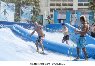PHUKET THAILAND - DECEMBER 28: Playing FlowRider  is a fun activity and is gaining popularity among tourists of all ages can play. on december 28,2014 at Kata Beach, Phuket, Thailand.