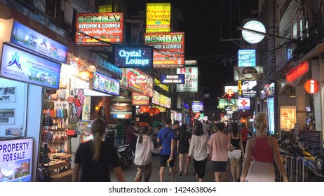 PHUKET – THAILAND, FEBRUARY 25, 2019, 4K Local shop by night, tourist people walk on commercial street 