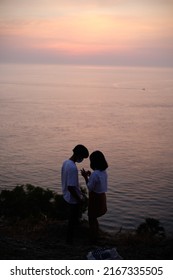 Phuket, Thailand - January 31 2022: Couple Enjoying A Pink Sunset In Promthep Cape, Thailand