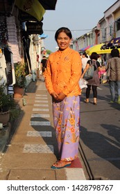 PHUKET, THAILAND - MARCH 23, 2019 : A Woman Wearing Nyonya Costume, It's The Costume Of Peranakan Woman, She Standing On Thalang Road In Phuket Old Town.