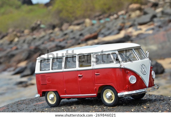 PHUKET, THAILAND - MARCH\
27, 2015: Miniature VW Bulli 1962 on the rock. The cult car of the\
Hippie generation and it remained the status vehicle of the high\
wave surfers