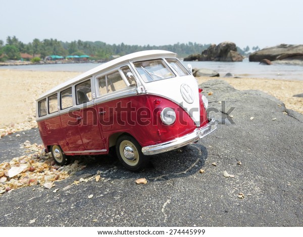 PHUKET, THAILAND - MARCH\
27, 2015: Miniature VW Bulli 1962 on the rock. The cult car of the\
Hippie generation and it remained the status vehicle of the high\
wave surfers