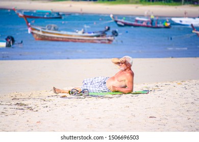 Phuket Thailand March 9 2019, Public Activities On The Beach,Old Man Sunbathing At The Beach