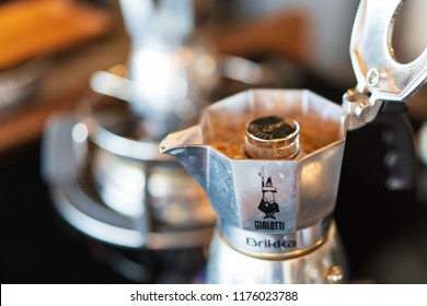 PHUKET, THAILAND - SEB 4, 2018: black coffee from silver moka pot, bialetti brand, home brewing style, blurred stove as background