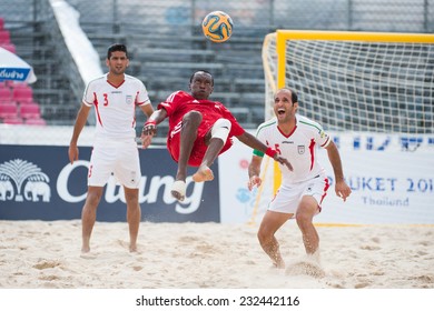 PHUKET THAILAND-NOVEMBER20 : Hasan Alhammadi  (red) Of UAE In Action During The Beach Soccer Match Between UAE And Iran The 2014 Asian Beach Games At Saphan Hin On Nov 20,2014 In Thailand