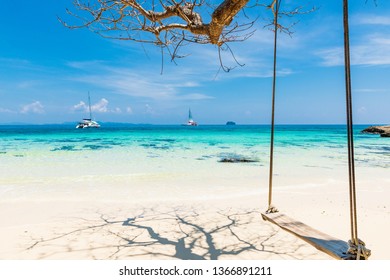 PHUKET,THAILAND-MARCH 7,2019: Simple wooden crib bindings Along the beach with emerald green water The sailboat is not far from the beach at Maiton Island