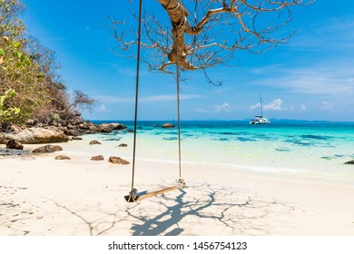 PHUKET,THAILAND-MARCH 7,2019: Simple wooden crib bindings Along the beach with emerald green water The sailboat is not far from the beach at Maiton Island