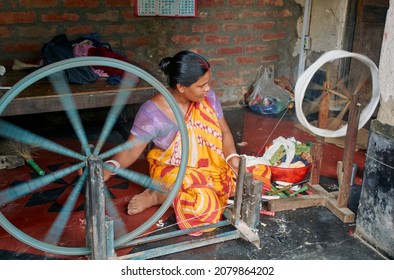 Phulia, West Bengal, 09-08-2021: A Housewife Spinning Cotton Threads With Help Of Manually Operated Charkha (spinning Wheel). Condition Of Economic Hardship Are Evident From Her Simple Lifestyle.