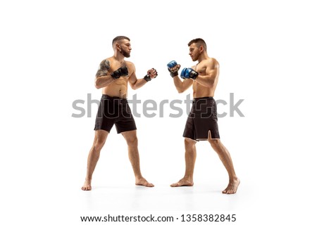 Phychology pressing. Two professional fighters posing isolated on white studio background. Couple of fit muscular caucasian athletes or boxers fighting. Sport, competition and human emotions concept.