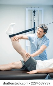Physal therapist working with patients limb hyperextension