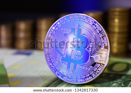 Physical Bitcoin BTC coin on a background with money