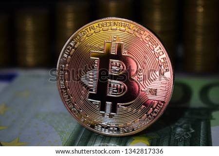 Physical Bitcoin BTC coin on a background with money