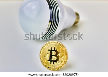 Physical bitcoin coin and big bulb