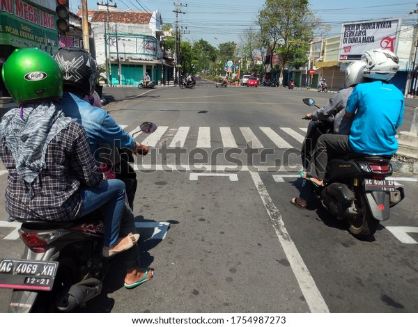 Physical\
distacing symbol or stop sign at a traffic light during the\
Pandemic 19 pandemic outbreak in Ahmad Yani Street, Nganjuk City,\
East Java, Indonesia (nganjuk, june 13,\
2020)