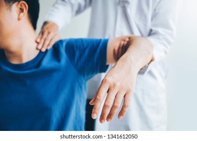 Physical Doctor consulting with patient About Shoulder muscule pain problems Physical therapy diagnosing concept - Shutterstock ID 1341612050