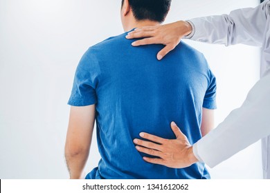 Physical Doctor consulting with patient about Back problems Physical therapy concept - Shutterstock ID 1341612062