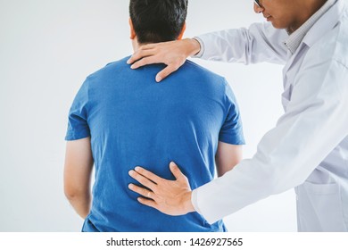 Physical Doctor consulting with patient about Back problems Physical therapy concept - Shutterstock ID 1426927565