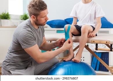 Physical Therapist Applying Young Patient Medical Tape