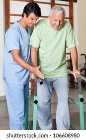 Physical therapist assisting senior man to walk with the support of bars at hospital gym