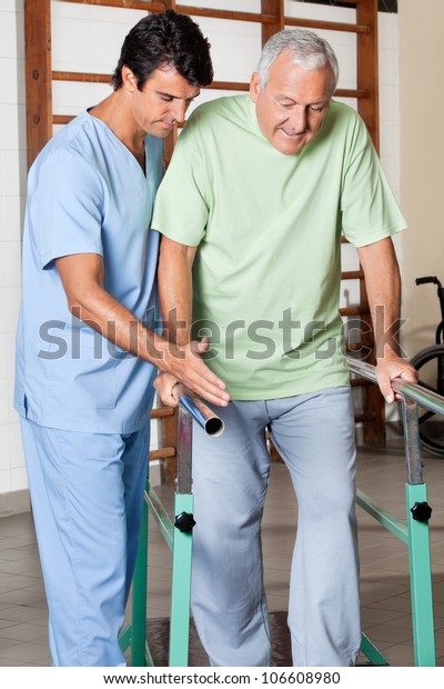 Physical Therapist Assisting Senior Man Walk Stock Photo 106608980 ...