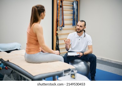 Physical therapist and athletic woman discussing about treatment plans at health club. - Shutterstock ID 2149530453