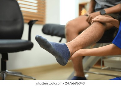 Physical therapist checking joint flexibility of athlete patient at clinic. Rehabilitation concept - Powered by Shutterstock