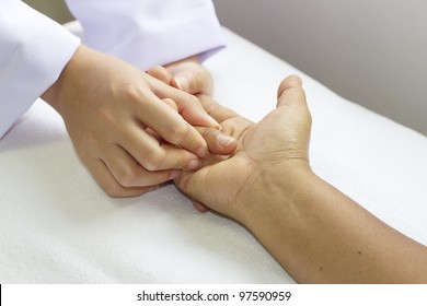 Physical Therapist Checks Range Of Motion For Finger And Hand