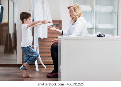 Physical Therapist Doing Medical Exam With Little Boy - Standing On One Leg, Checking Balance