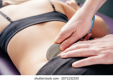 Physical therapist fixing sacroiliac joint or SI joint pain with IASTM guasha tool, Instrument assisted soft tissue mobilization technique for soft tissue treatment