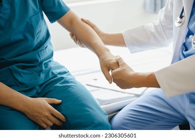 physical therapist helping man physical therapy rehabilitation - Shutterstock ID 2306305601