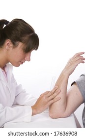 Physical Therapist Measures The Range Of Motion In An Elbow With A Goiniometer