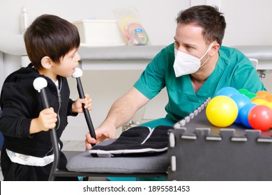 Physical Therapist Playing With Children, With Cerebral Palsy. High Quality Photo