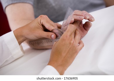 Physical Therapist Uses A Goiniometer To Test Range Of Motion