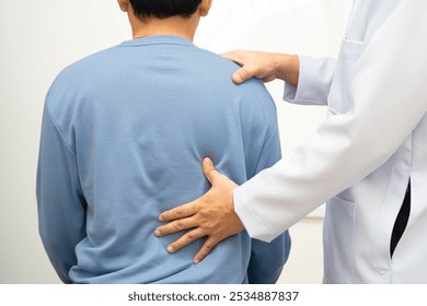 Physical therapy, Asian therapist doctor treat perform pain young man in hospital. - Powered by Shutterstock